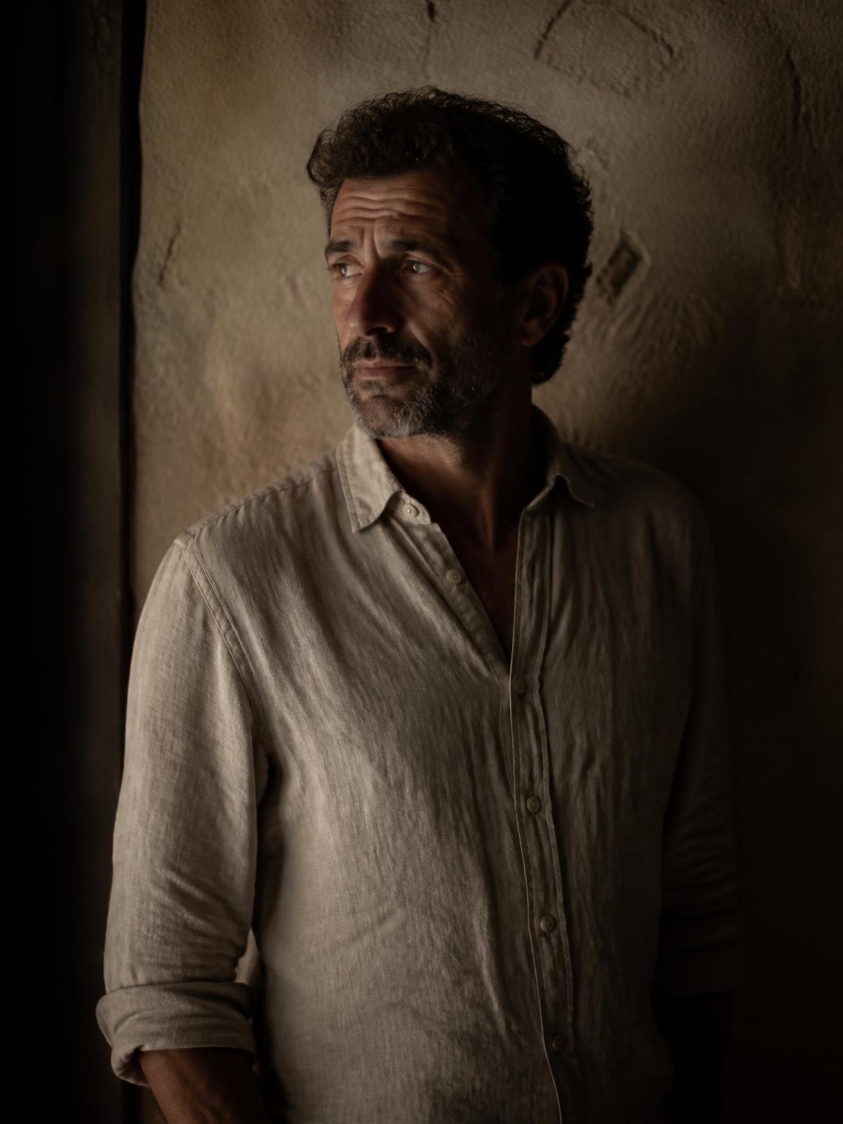 Portrait in low warm light, a quiet moment during filming.